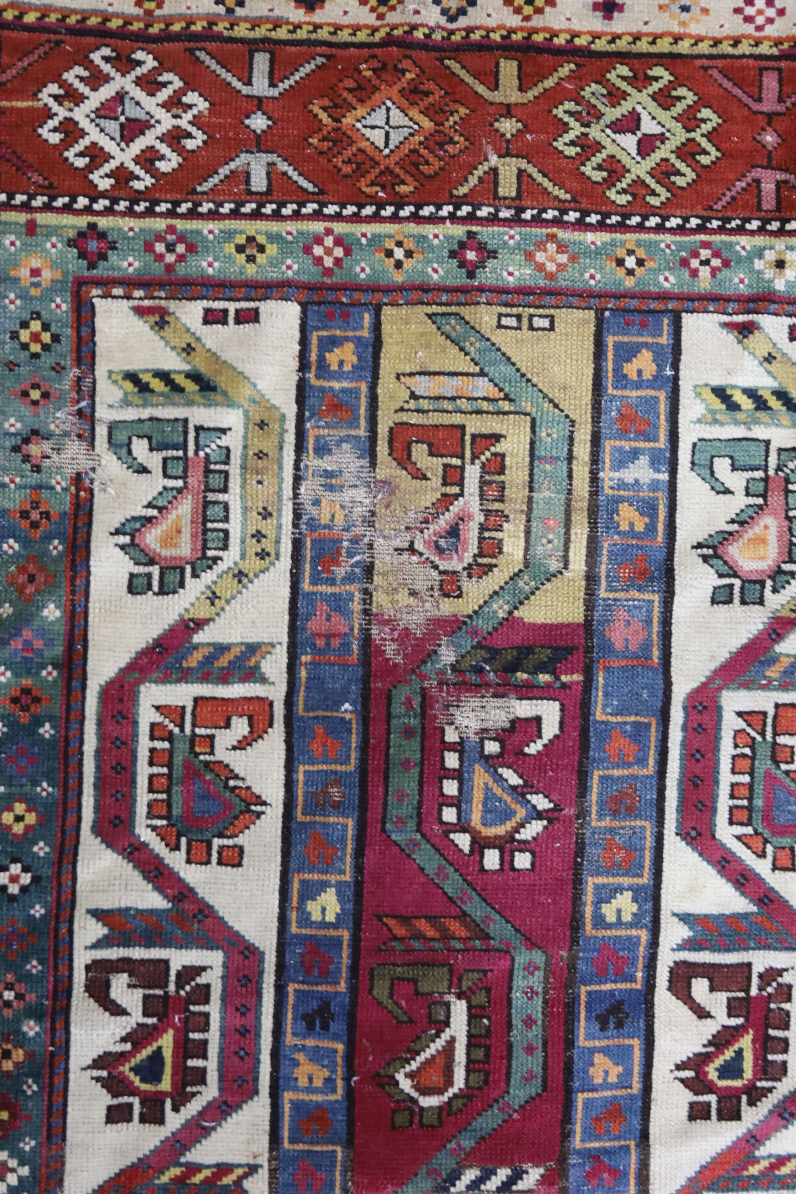 A Caucasian geometric rug, 284 x 118cm